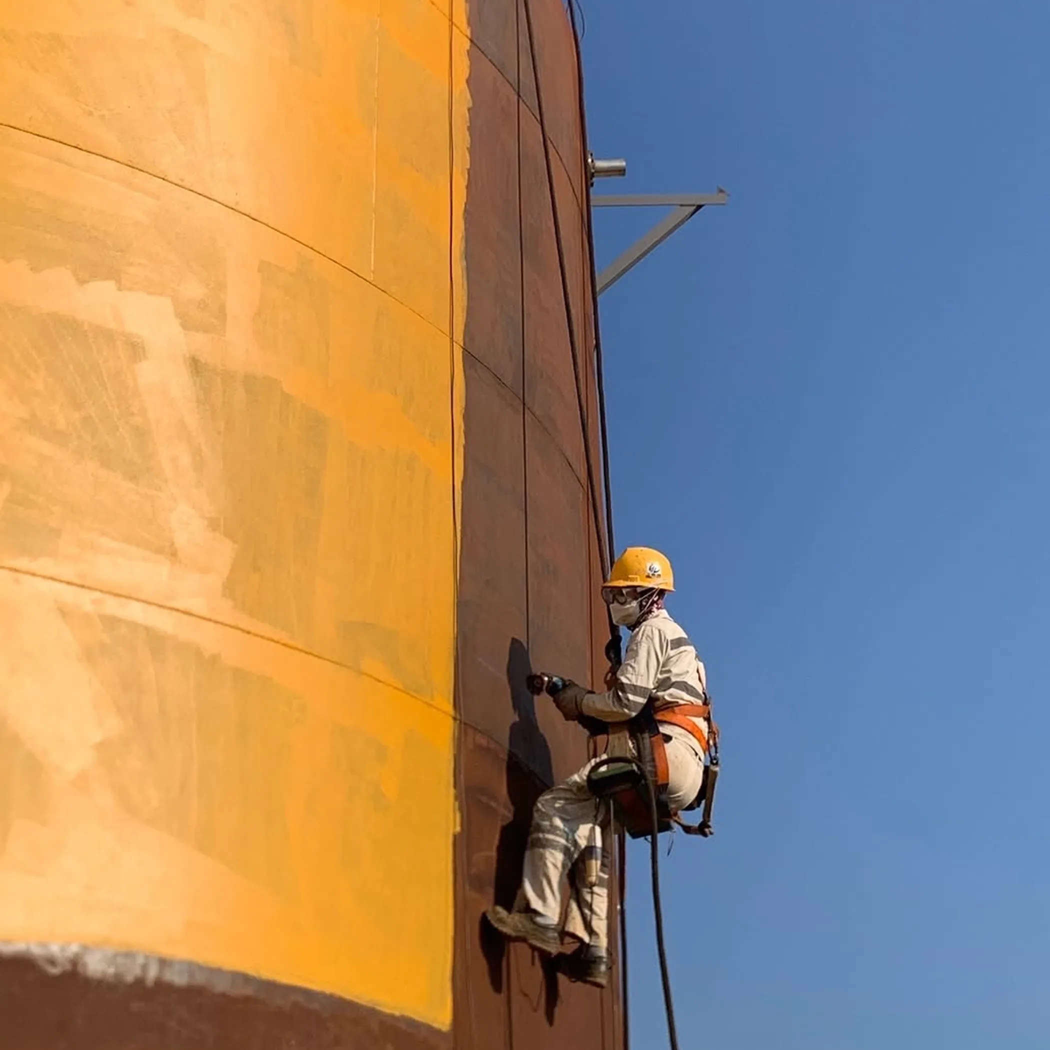 certified rope-access worker on industrial surface
