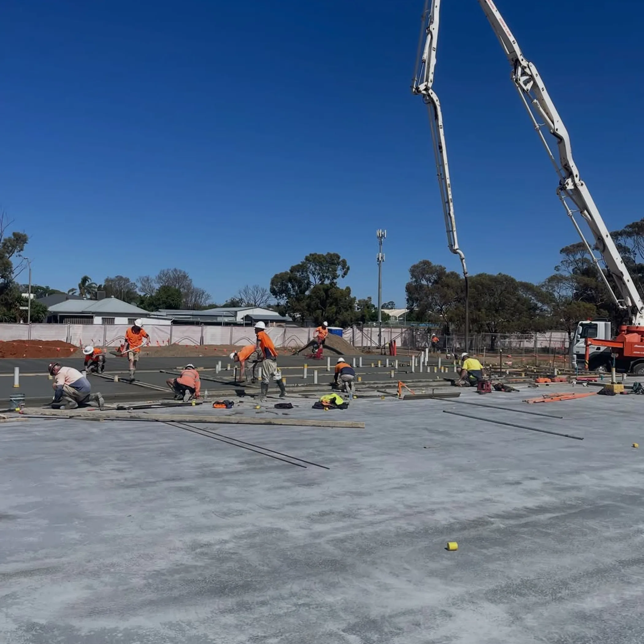construction workers and concrete boom pump